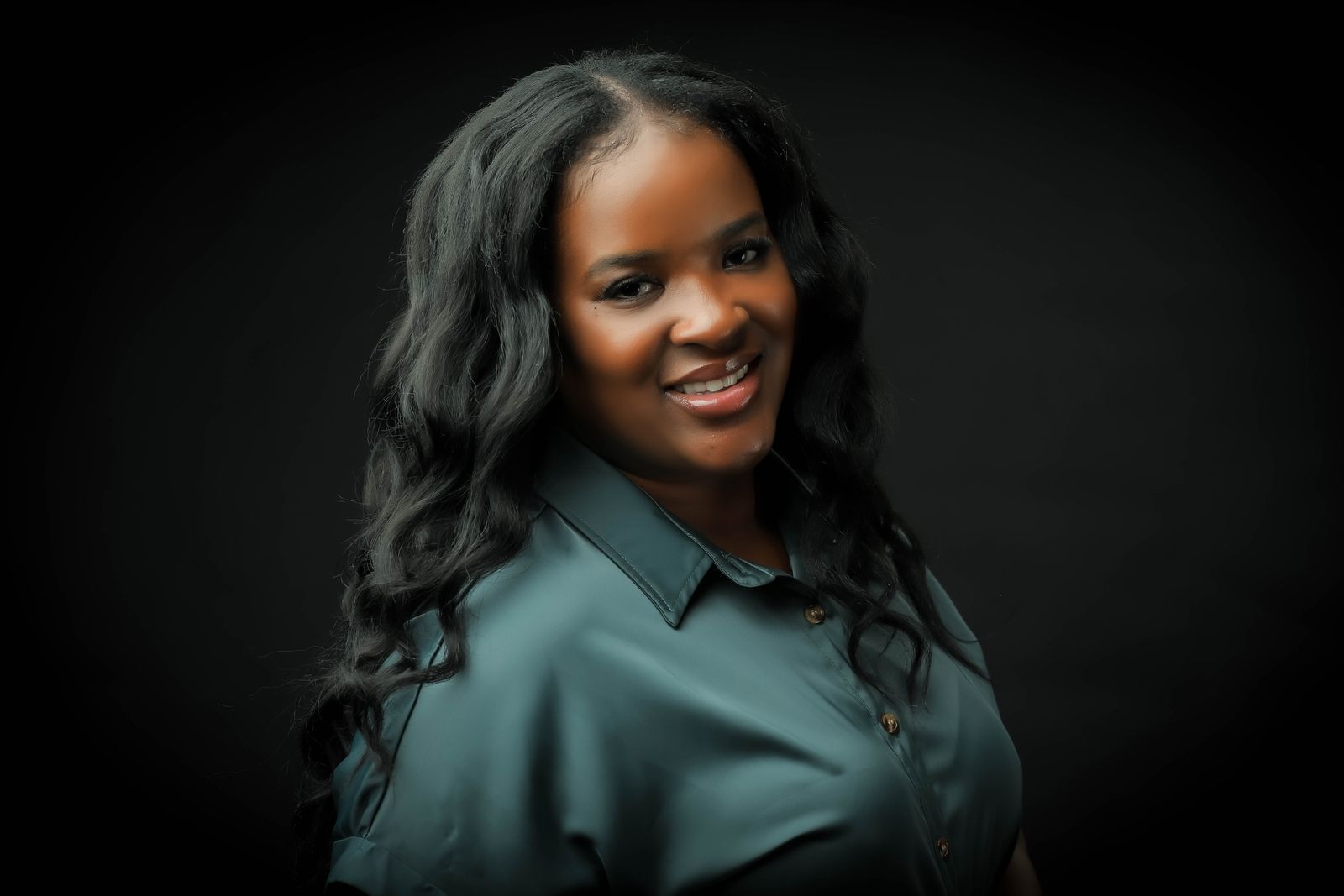 Hadassa Felix, founder of the Love 518 Method, smiling in a green blouse